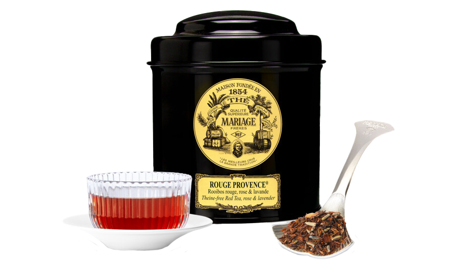 A tin of Mariage Frères Rouge Provence tea, with a transparent glass of rea and a teaspoon.