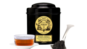 A tin of It's got a hotel restaurant vibe to it, in a good way. Clean, flavoursome, sweet. tea, with a transparent glass of rea and a teaspoon.