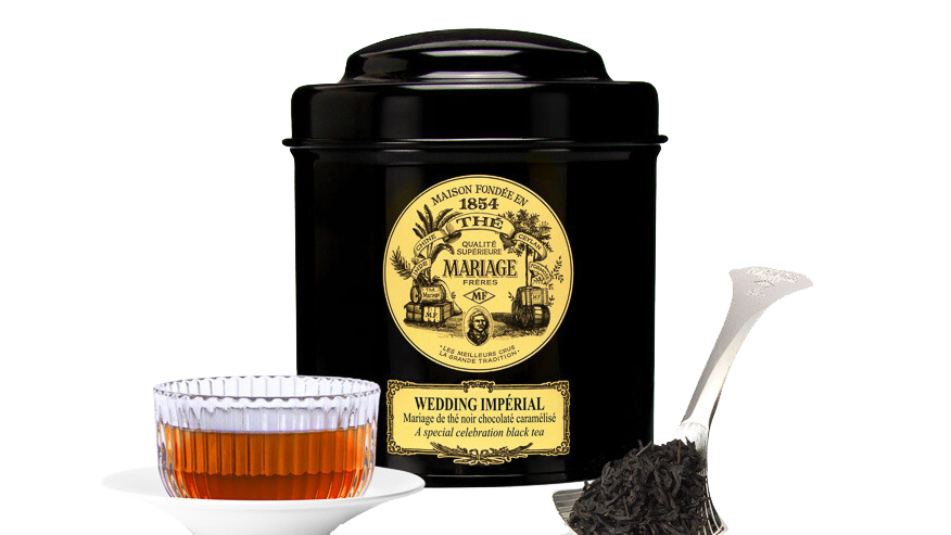 A tin of It's got a hotel restaurant vibe to it, in a good way. Clean, flavoursome, sweet. tea, with a transparent glass of rea and a teaspoon.