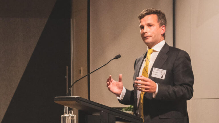 David Semour standing at a podium.